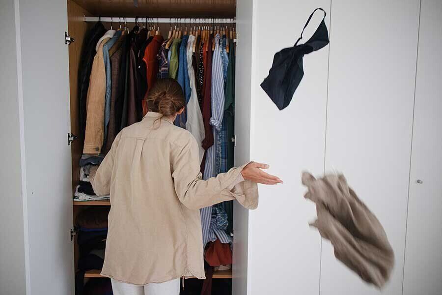 An image of a woman organising her clutter in a bid to clear the chi energy in her living space