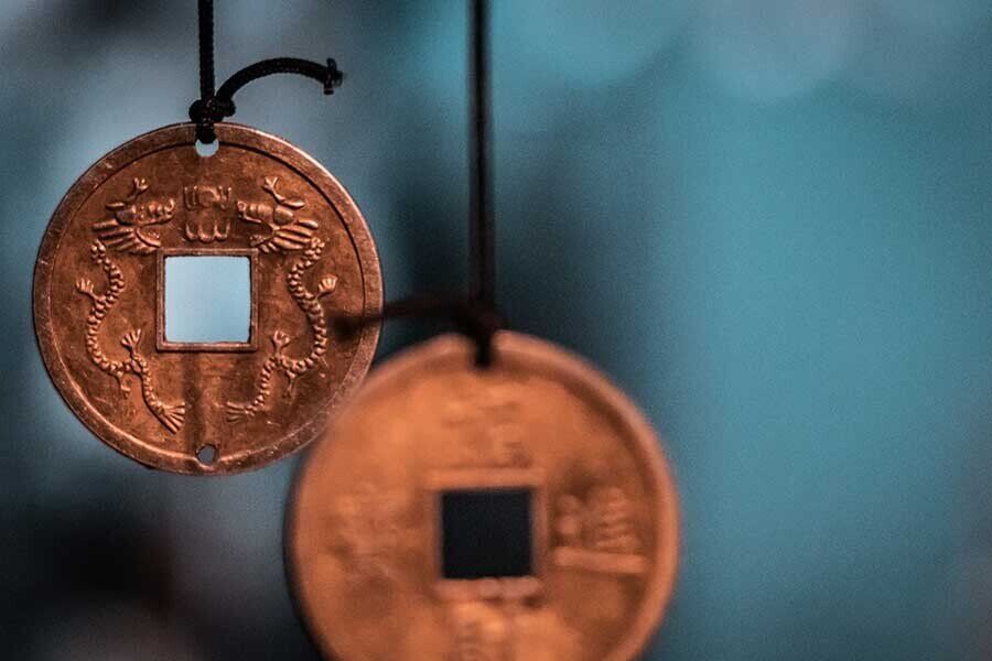 A photo of a i ching coin. Understanding Feng Shui enhancement - i ching coins improve the chi energy as per the bagua
