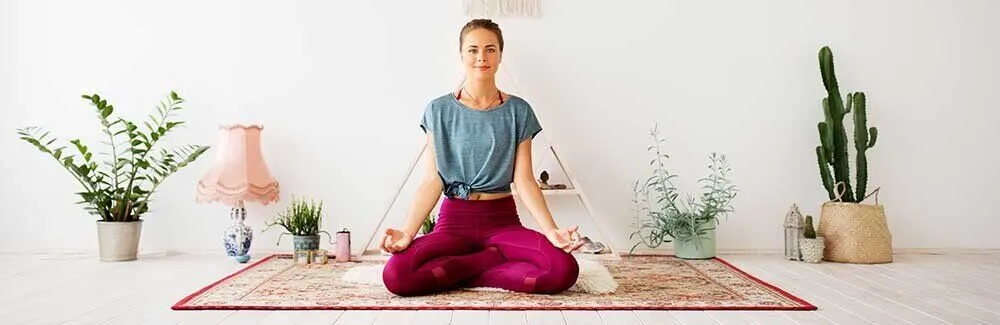 Person practicing self-care strategies through meditation
